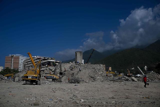 Heavy machinery clears the rubble of a collapsed building in Caraballeda, Venezuela, on September 2, 2026. The magnitude 7.2 and 7.5 tremors on June 24, 2026, devastated the coastal state of La Guaira, where at least 190 buildings fell apart. Venezuela's interim government reported 6,509 deaths on August 24, 2026, exactly two months after the twin earthquakes. (Photo by Federico PARRA / AFP)