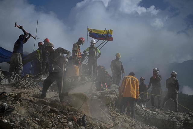 Rescue teams and volunteers search for bodies amid the rubble of a collapsed building in Caraballeda, Venezuela, on September 2, 2026. The magnitude 7.2 and 7.5 tremors on June 24, 2026, devastated the coastal state of La Guaira, where at least 190 buildings fell apart. Venezuela's interim government reported 6,509 deaths on August 24, 2026, exactly two months after the twin earthquakes. (Photo by Federico PARRA / AFP)