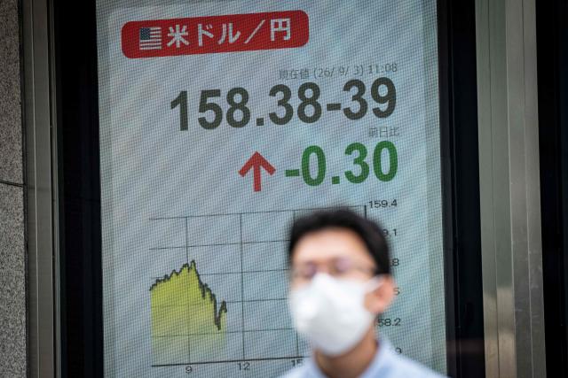 A man walks past an electronic quotation board displaying the foreign exchange rate of the Japanese yen against the US dollar in Tokyo on September 3, 2026. (Photo by Yuichi YAMAZAKI / AFP)