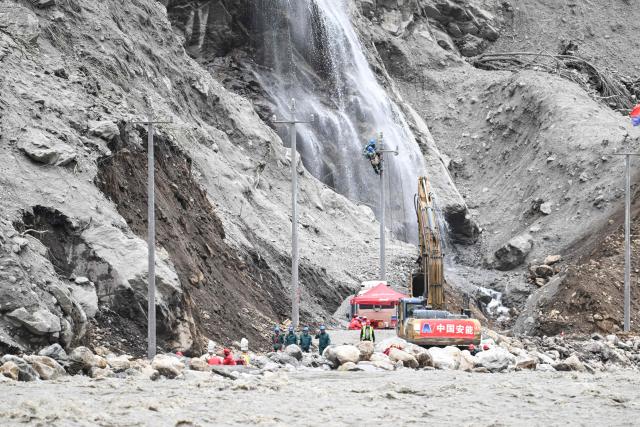 State Grid personnel repair power lines on the road leading to the destroyed Gyirong Port in Gyirong County, in China’s western Tibet region on September 2, 2026. (Photo by CNS / AFP) / China OUT