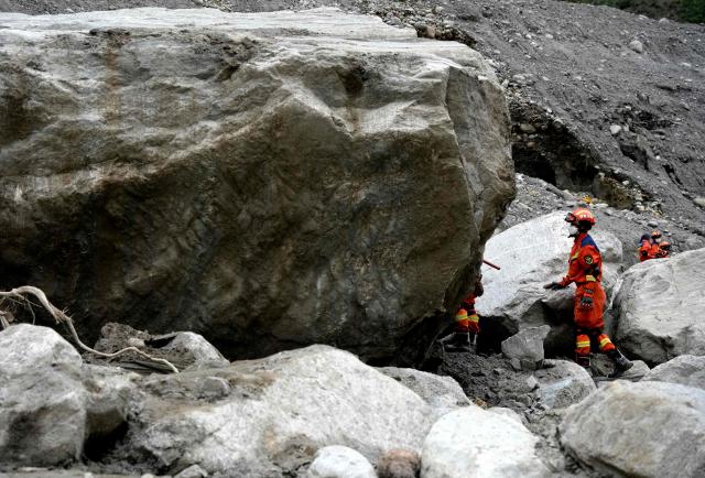 Rescue personnel search through the debris left by a mudslide in the area around the destroyed Gyirong Port in Gyirong County, in China’s western Tibet region on September 2, 2026. (Photo by CNS / AFP) / China OUT
