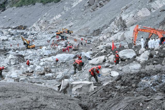 Rescue personnel search through the debris left by a mudslide in the hardest-hit area around the destroyed Gyirong Port in Gyirong County, in China’s western Tibet region on September 2, 2026. (Photo by CNS / AFP) / China OUT