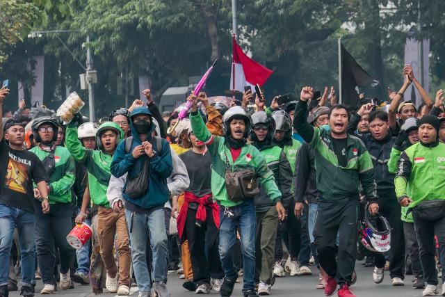 (FILES) Ride-hailing motorcycle drivers take part in a demonstration urging lawmakers to immediately pass an asset forfeiture law for corruptors outside the Parliament building in Jakarta on August 27, 2026. Disinformation about ongoing anti-government protests in Indonesia has inundated social media in what investigators say is a coordinated attempt to spread propaganda about the one-year-old movement. (Photo by AZWAR IPANK / AFP)