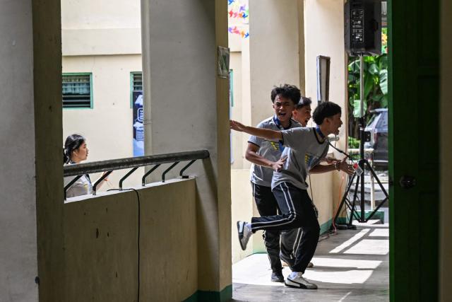 Students react during a nationwide school drills to safeguard students from armed intruders, at a school in San Rafael, Bulacan on September 3, 2026. The drills came following a student livestreaming himself shooting another schoolmate dead before taking his own life at a high school in the Philippines on August 18, authorities said. (Photo by Jam STA ROSA / AFP)
