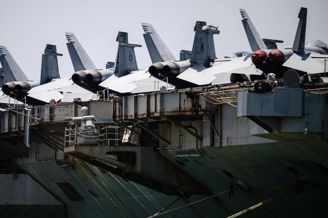F/A-18E Super Hornets are seen on the flight deck of USS Abraham Lincoln (CVN-72) while docked at Laem Chabang Port, near the city of Pattaya on September 3, 2026.  (Photo by ANTHONY WALLACE / AFP)