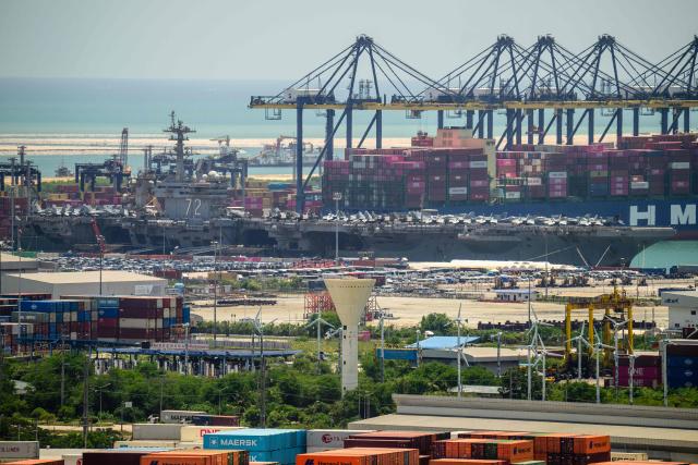 US nuclear-powered aircraft carrier USS Abraham Lincoln (CVN-72) (R) is seen docked at Laem Chabang Port, near the city of Pattaya on September 3, 2026.  (Photo by ANTHONY WALLACE / AFP)