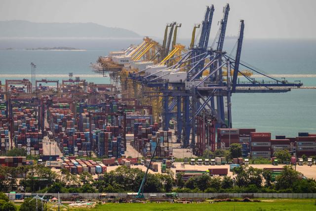 Cargo containers and ship-to-shore (STS) container cranes are seen at Laem Chabang Port, near the city of Pattaya on September 3, 2026. (Photo by ANTHONY WALLACE / AFP)