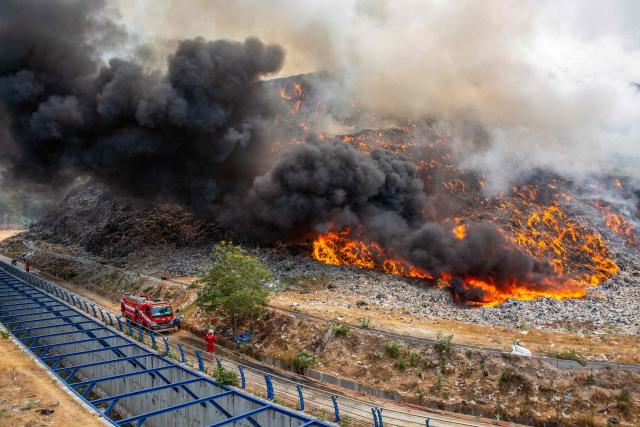 Firefighters work at the scene of a fire at the Putri Cempo landfill in Solo, Central Java on September 3, 2026. (Photo by Devi RAHMAN / AFP)