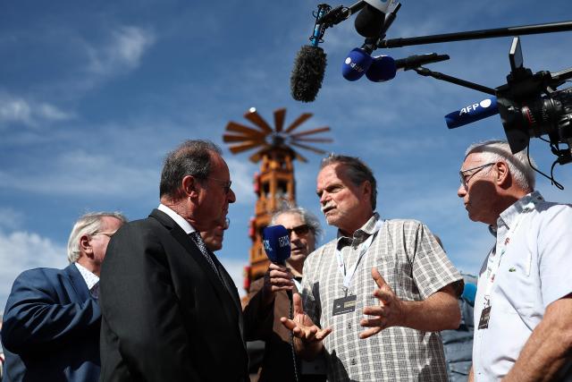 Former French President and Socialistes et Apparentes' MP Francois Hollande (L) speaks with a participant as he visits the agricultural fair in Chalons-en-Champagne, northeastern France on September 3, 2026. (Photo by Sameer AL-DOUMY / AFP)