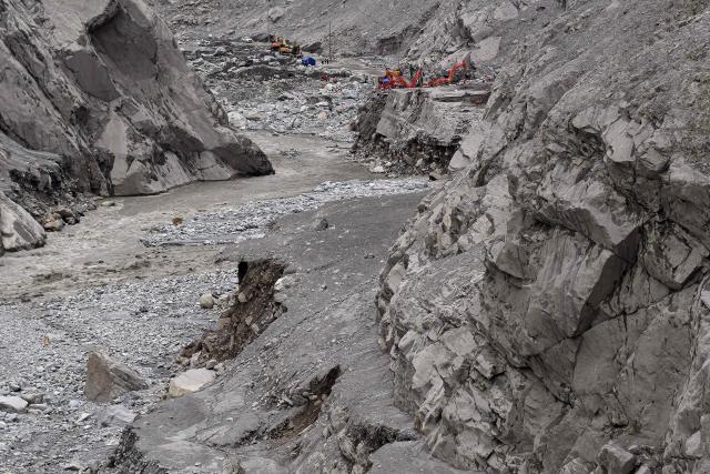 An aerial view shows excavators and rescue personnel in Gyirong region on China-Nepal border, in the aftermath of flash floods as seen from Timure in Nepal's Rasuwa district on September 3, 2026. (Photo by Manan VATSYAYANA / AFP)