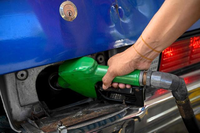 A worker refuels a car at a gas station in Caracas on September 3, 2026. (Photo by Federico PARRA / AFP)