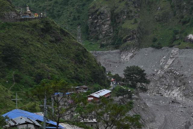 An aerial view shows houses damaged and deluged in sludge in the aftermath of flash floods at Syabrubesi in Nepal's Rasuwa district on September 3, 2026. More than 1,200 people have been killed and nearly 5,000 are missing on both sides of the China-Nepal border since the catastrophic glacial mountain collapse on August 26, according to tolls by both nations on September 3. (Photo by Prakash MATHEMA / AFP)