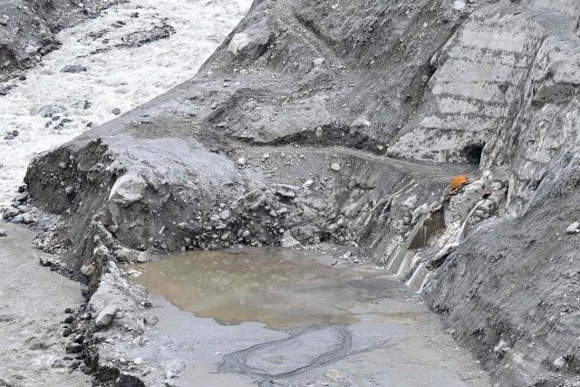 An aerial view shows remains of a damaged structure in the aftermath of flash floods at Syabrubesi in Nepal's Rasuwa district on September 3, 2026. More than 1,200 people have been killed and nearly 5,000 are missing on both sides of the China-Nepal border since the catastrophic glacial mountain collapse on August 26, according to tolls by both nations on September 3. (Photo by Prakash MATHEMA / AFP)