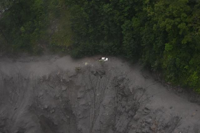 An aerial view shows a car stuck in a landslide in the aftermath of flash floods at Syabrubesi in Nepal's Rasuwa district on September 3, 2026. More than 1,200 people have been killed and nearly 5,000 are missing on both sides of the China-Nepal border since the catastrophic glacial mountain collapse on August 26, according to tolls by both nations on September 3. (Photo by Prakash MATHEMA / AFP)