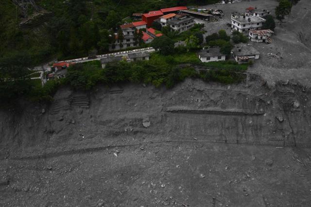 An aerial view shows Chilime Hydropower station deluged in sludge in the aftermath of flash floods at Syabrubesi in Nepal's Rasuwa district on September 3, 2026. More than 1,200 people have been killed and nearly 5,000 are missing on both sides of the China-Nepal border since the catastrophic glacial mountain collapse on August 26, according to tolls by both nations on September 3. (Photo by Prakash MATHEMA / AFP)