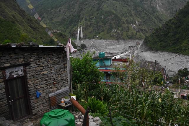 An aerial view shows houses damaged and deluged in sludge in the aftermath of flash floods at Syabrubesi in Nepal's Rasuwa district on September 3, 2026. More than 1,200 people have been killed and nearly 5,000 are missing on both sides of the China-Nepal border since the catastrophic glacial mountain collapse on August 26, according to tolls by both nations on September 3. (Photo by Prakash MATHEMA / AFP)