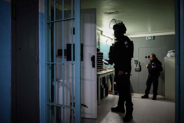 (FILES) A member (C) of the Regional Intervention and Security Teams (ERIS) waits for the end of the body search before the transfer of a high-security inmate from the Gradignan prison to the newly operational high-security prison of Conde-sur-Sarthe, in Gradignan, southwestern France, on November 20, 2025. The Council of State rejected on September 3, 2026 the appeal filed by Minister of Justice Gerald Darmanin, in which he sought to overturn a decision by a judge in summary proceedings ordering an end to “conduct contrary to professional ethics” committed against inmates at the Conde-sur-Sarthe prison (Orne). (Photo by Philippe LOPEZ / AFP)