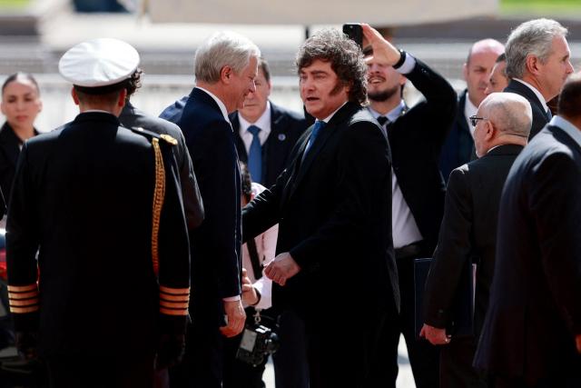 Chile's President Jose Antonio Kast (L) accompanies Argentina's President Javier Milei (C) as he leaves La Moneda presidential palace following a meeting in Santiago on September 3, 2026. (Photo by Raul BRAVO / AFP)
