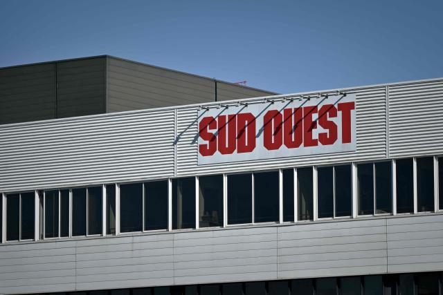 This photograph taken on September 3, 2026 shows a sign on the printing house of French regional daily newspaper Sud Ouest, on the banks of the Garonne river in the Bastide district of Bordeaux, southwestern France. The parent company of the regional daily "Sud Ouest" has entered into “exclusive negotiations” for a takeover by the Belgian company Rossel, which already owns "La Voix du Nord" in France, the two groups announced on September 3, 2026. (Photo by Philippe LOPEZ / AFP)