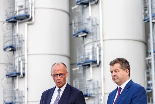 Chancellor and leader of the Christian Democratic Union (CDU) Friedrich Merz (L) and State Premier of Saxony-Anhalt and lead candidate in the state election Sven Schulze (R) address the media on September 3, 2026 in front of the Finnish UPM Biochemicals company in Leuna, eastern Germany, ahead of the Saxony-Anhalt state election on September 6. The 2026 Saxony-Anhalt state election to elect the 9th Landtag of Saxony-Anhalt will be held on September 6, 2026. (Photo by Jens SCHLUETER / AFP)