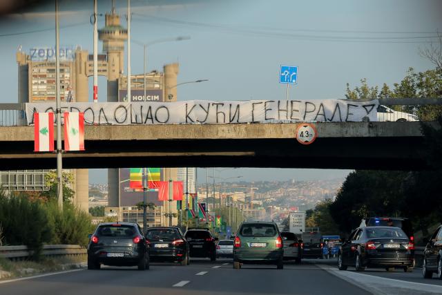 A banner reading "Welcome Home, General" is displayed on a footbridge over a motorway as a convoy carrying the body of Bosnian Serb war criminal Ratko Mladic passes through Belgrade, Serbia, on September 3, 2026. Mladic's body arrived in Serbia earlier in the day and was driven from the airport under police escort after being received with military honours. Mladic died the previous week while serving a life sentence for genocide, war crimes and crimes against humanity committed during the 1992-1995 Bosnian war. (Photo by Pedja MILOSAVLJEVIC / AFP)