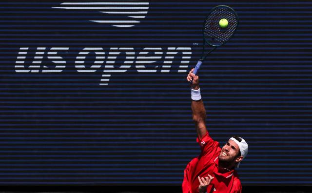 Russia's Karen Khachanov serves to Canada's Felix Auger-Aliassime during their men's singles second round tennis match on day five of the US Open tennis tournament at the USTA Billie Jean King National Tennis Center in New York City on September 3, 2026. (Photo by TIMOTHY A. CLARY / AFP)