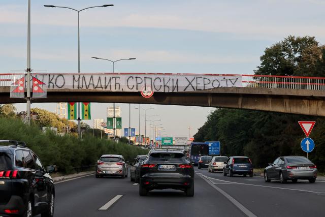 A banner reading "Ratko Mladic, Serbian Hero" is displayed on a footbridge over a motorway as a convoy carrying the body of Bosnian Serb war criminal Ratko Mladic passes through Belgrade, Serbia, on September 3, 2026. Mladic's body arrived in Serbia earlier in the day and was driven from the airport under police escort after being received with military honours. Mladic died the previous week while serving a life sentence for genocide, war crimes and crimes against humanity committed during the 1992-1995 Bosnian war. (Photo by Pedja MILOSAVLJEVIC / AFP)
