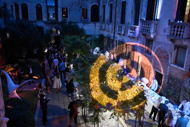 Guests attend a ball for the inauguration of the Palazzo Bragadin, a former residence of fashion designer Pierre Cardin turned into a museum, in Venice on September 3, 2026. The museum, which will open to the public on 12 September 2026, will house over 350 works (historic and contemporary creations, original drawings, haute couture pieces, furniture, lamps and design objects) spread over an area of almost one thousand square metres. (Photo by ANDREA PATTARO / AFP)