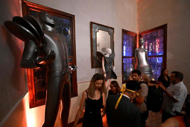 Guests attend a ball for the inauguration of the Palazzo Bragadin, a former residence of fashion designer Pierre Cardin turned into a museum, in Venice on September 3, 2026. The museum, which will open to the public on 12 September 2026, will house over 350 works (historic and contemporary creations, original drawings, haute couture pieces, furniture, lamps and design objects) spread over an area of almost one thousand square metres. (Photo by ANDREA PATTARO / AFP)