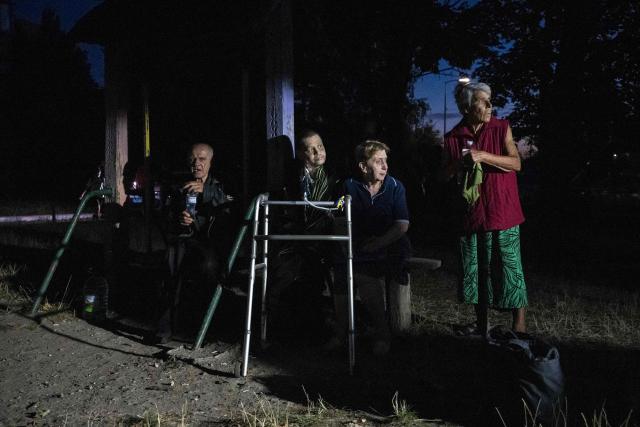 Residents wait outside a damaged residential building following a Russian strike in Kyiv on September 3, 2026, amid the Russian invasion of Ukraine. (Photo by Vladyslav Musiienko / AFP)