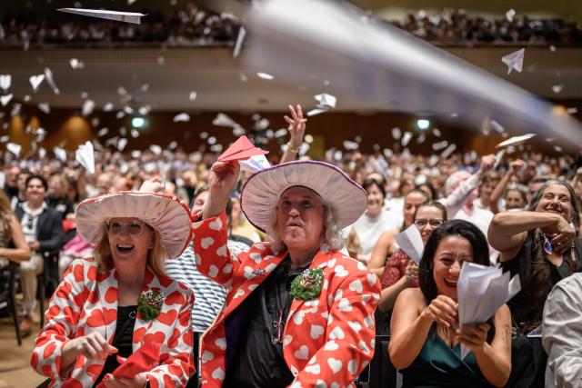 As part of a long-standing Ig Nobel tradition, members of the audience toss paper airplanes during the 2026 Ig Nobel Prize Ceremony in Zurich, on September 3, 2026. The Ig Nobel Prize is a parody of the Nobel Prize, which is awarded every autumn to celebrate ten unusual or trivial achievements in scientific research. (Photo by Fabrice COFFRINI / AFP)