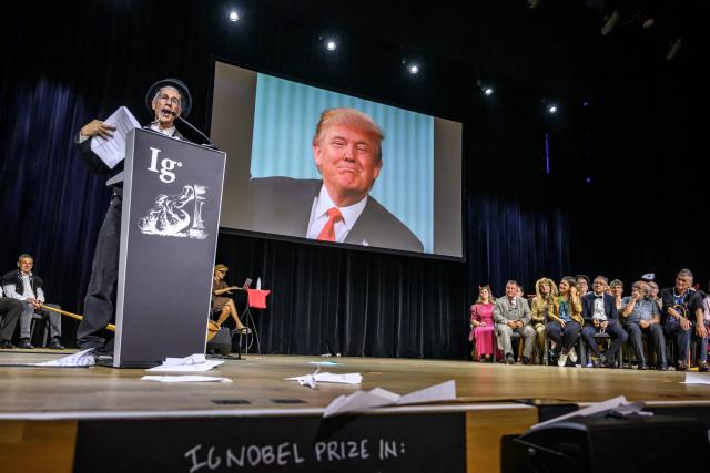 A picture of US President Donald Trump is displayed during the 2026 Ig Nobel Prize Ceremony in Zurich, on September 3, 2026. For the first time in their history, the Ig Nobel Prize ceremony was moved outsite of the US after organizers cited concerns about immigration policies and the ability of international scientists to enter the United States. The parody of the Nobel Prize awards every autumn celebrates ten unusual or trivial achievements in scientific research. (Photo by Fabrice COFFRINI / AFP)