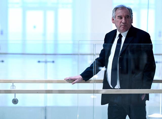 (FILES) Head of French MoDem centrist party Francois Bayrou walks at the Paris Judicial court, northern district of Paris on February 5, 2024, on the day of the decision of Paris court in his trial and ten other centrist executives and elected representatives, on charges of complicity in the misappropriation of public funds in a scandal over MoDem European parliamentary assistants. The appeal trial of François Bayrou along with ten other people, for alleged complicity in the misappropriation of public funds in a scandal over MoDem European parliamentary assistants will run from September 9 to October 5, 2026. (Photo by MIGUEL MEDINA / AFP)
