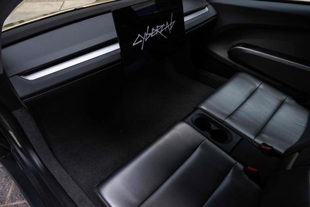 The interior of a Tesla's "Cybercab" is shown as it's displayed in downtown Austin, Texas, on September 3, 2026. Tesla is launching the "Cybercab" which is a taxi with no steering wheel or pedals, designed purely for autonomy. (Photo by RONALDO SCHEMIDT / AFP)