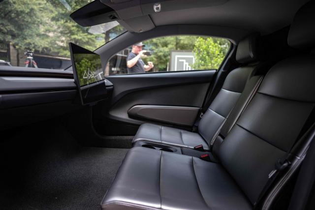 The interior of a Tesla's "Cybercab" is shown as it's displayed in downtown Austin, Texas, on September 3, 2026. Tesla is launching the "Cybercab" which is a taxi with no steering wheel or pedals, designed purely for autonomy. (Photo by RONALDO SCHEMIDT / AFP)