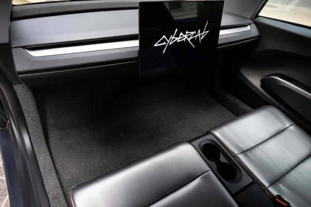 The interior of a Tesla's "Cybercab" is shown as it's displayed in downtown Austin, Texas, on September 3, 2026. Tesla is launching the "Cybercab" which is a taxi with no steering wheel or pedals, designed purely for autonomy. (Photo by RONALDO SCHEMIDT / AFP)