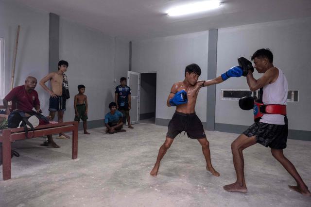 This photo taken on May 27, 2026 shows fighters training in traditional Myanmar boxing known as Lethwei at a training camp in Hpa-an in Myanmar's Karen state. In a country consumed by conflict, a sport defined by brutality dominates: Myanmar's lethwei martial art, where headbutts are encouraged and knock-out blows are the aim of the game. (Photo by Sai Aung MAIN / AFP) / To go with AFP story Myanmar-conflict-lifestyle-box, FOCUS by Hla-Hla Htay and Joe Stenson