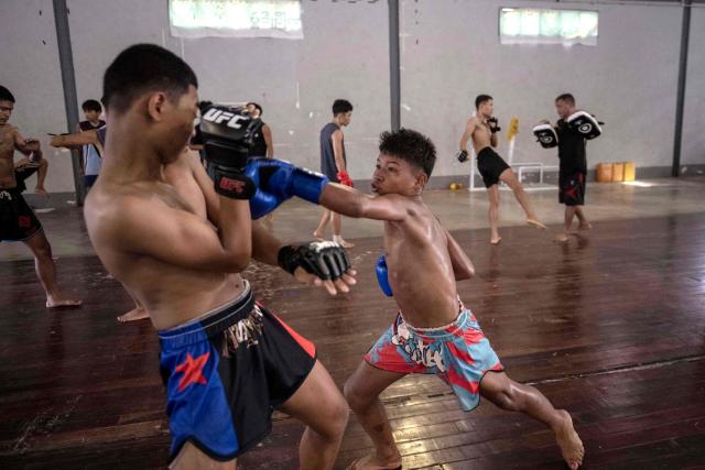 This photo taken on May 27, 2026 shows fighters training in traditional Myanmar boxing known as Lethwei at a training camp in Hpa-an in Myanmar's Karen state. In a country consumed by conflict, a sport defined by brutality dominates: Myanmar's lethwei martial art, where headbutts are encouraged and knock-out blows are the aim of the game. (Photo by Sai Aung MAIN / AFP) / To go with AFP story Myanmar-conflict-lifestyle-box, FOCUS by Hla-Hla Htay and Joe Stenson