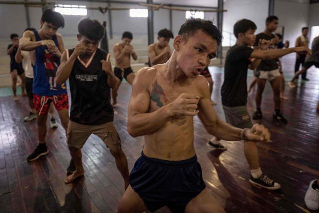 TOPSHOT - This photo taken on May 28, 2026 shows fighters training in traditional Myanmar boxing known as Lethwei at a training camp in Hpa-an in Myanmar's Karen state. In a country consumed by conflict, a sport defined by brutality dominates: Myanmar's lethwei martial art, where headbutts are encouraged and knock-out blows are the aim of the game. (Photo by Sai Aung MAIN / AFP) / To go with AFP story Myanmar-conflict-lifestyle-box, FOCUS by Hla-Hla Htay and Joe Stenson
