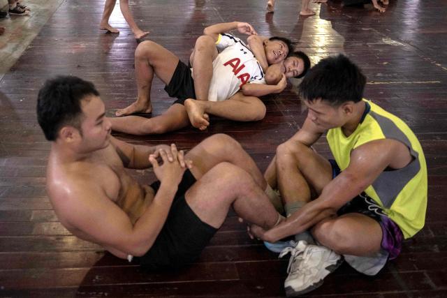 This photo taken on May 28, 2026 shows fighters training in traditional Myanmar boxing known as Lethwei at a training camp in Hpa-an in Myanmar's Karen state. In a country consumed by conflict, a sport defined by brutality dominates: Myanmar's lethwei martial art, where headbutts are encouraged and knock-out blows are the aim of the game. (Photo by Sai Aung MAIN / AFP) / To go with AFP story Myanmar-conflict-lifestyle-box, FOCUS by Hla-Hla Htay and Joe Stenson