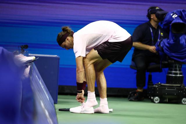 Germany's Alexander Zverev changes his shoes during the men's singles second round tennis match against France's Quentin Halys on day five of the US Open tennis tournament at the USTA Billie Jean King National Tennis Center in New York City on September 3, 2026. (Photo by CHARLY TRIBALLEAU / AFP)
