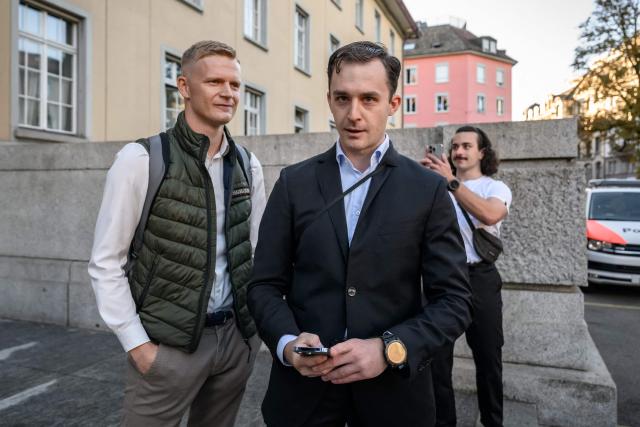 Leading figures of the Swiss far-right group Junge Tat Tobias Lingg (L) and Manuel Corchia (C) arrive at Zurich District Court for their trail, in Zurich, on September 4, 2026. Six people from the far-right group Junge Tat appeared before the Zurich District Court, accused of hatred-related offenses, coercion, rioting, property damage and trespassing. The group's two main leaders face up to six months in prison. (Photo by Fabrice COFFRINI / AFP)
