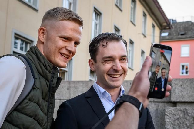 Leading figures of the Swiss far-right group Junge Tat Tobias Lingg (L) and Manuel Corchia smile as they are filmed while arriving at Zurich District Court for their trial, in Zurich, on September 4, 2026. Six people from the far-right group Junge Tat appeared before the Zurich District Court, accused of hatred-related offenses, coercion, rioting, property damage and trespassing. The group's two main leaders face up to six months in prison. (Photo by Fabrice COFFRINI / AFP)