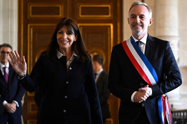 (FILES) Former Mayor of Paris Anne Hidalgo (L) leaves the city hall with Paris' newly elected Mayor Emmanuel Grйgoire wearing the tricolour mayoral sash after being nominated during the inaugural city council session at the city hall of Paris on March 29, 2026. More than fifteen families who have reported violence and sexual abuse against their children during after-school care announced on September 4, 2026, that they were filing a complaint against the City of Paris and its Socialist mayor, Emmanuel Gregoire, as well as his predecessor, Anne Hidalgo. United under the MeTooEcole association, these families – whose children attend various schools across the capital – are calling on the courts to investigate what the local authorities knew about the failings in after-school care, and their alleged failure to take action to remedy them. (Photo by JULIEN DE ROSA / POOL / AFP)