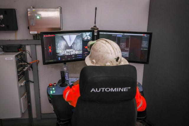 A driver uses a computer to drive a truck carrying loads through the underground CSA Cobar copper mine, operated by Harmony Gold Mining company, located north of the New South Wales town of Cobar on September 4, 2026. (Photo by DAVID GRAY / AFP)