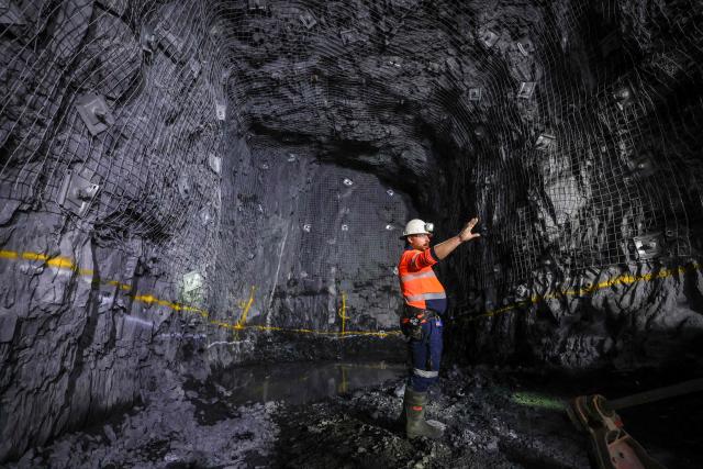 A worker checks the development drive created by a multi-purpose rock drilling machine known as a ‘jumbo’ in the underground CSA Cobar copper mine, operated by Harmony Gold Mining company, located north of the New South Wales town of Cobar on September 4, 2026. (Photo by DAVID GRAY / AFP)