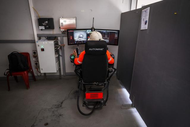 A driver uses a computer to drive a truck carrying loads through the underground CSA Cobar copper mine, operated by Harmony Gold Mining company, located north of the New South Wales town of Cobar on September 4, 2026. (Photo by DAVID GRAY / AFP)