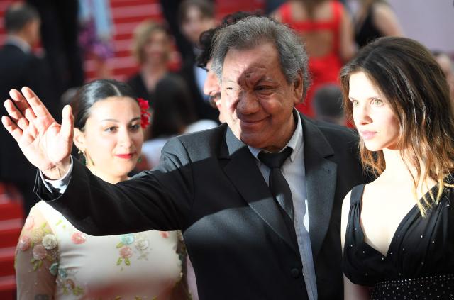 (FILES) French director Tony Gatlif (C) and actress Daphne Patakia (R) arrive on May 25, 2017 for the screening of the tv series 'Twin Peaks' at the 70th edition of the Cannes Film Festival in Cannes, southern France. Filmmaker Tony Gatlif, a champion of Romani culture with some 20 films to his credit, including “Gadjo Dilo,” died at the age of 77, his family told AFP on September 4, 2026. (Photo by Anne-Christine POUJOULAT / AFP)