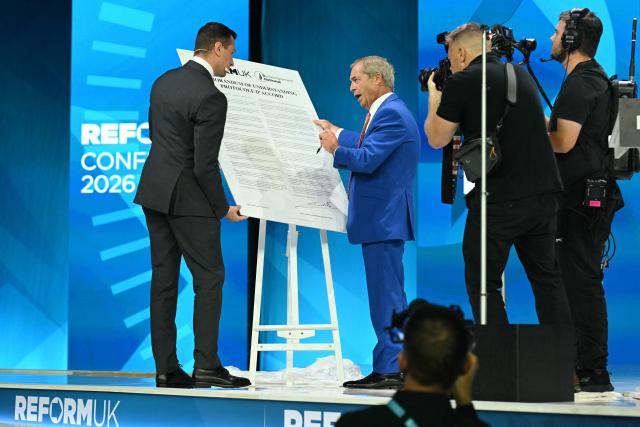 Reform UK Leader Nigel Farage (R) and President of French far-right party Rassemblement National (RN) Jordan Bardella sign a Memorandum of Understanding between the two parties, on the second day of the annual Reform UK party conference at the NEC in Birmingham, central England on September 4, 2026. (Photo by Oli SCARFF / AFP)