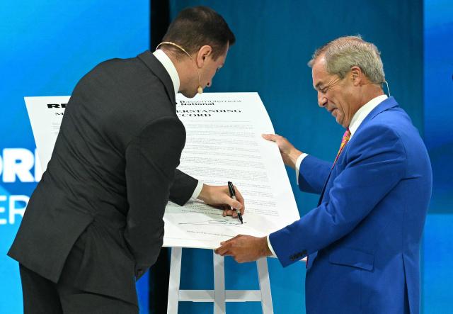 Reform UK Leader Nigel Farage (R) and President of French far-right party Rassemblement National (RN) Jordan Bardella sign a Memorandum of Understanding between the two parties, on the second day of the annual Reform UK party conference at the NEC in Birmingham, central England on September 4, 2026. (Photo by Oli SCARFF / AFP)